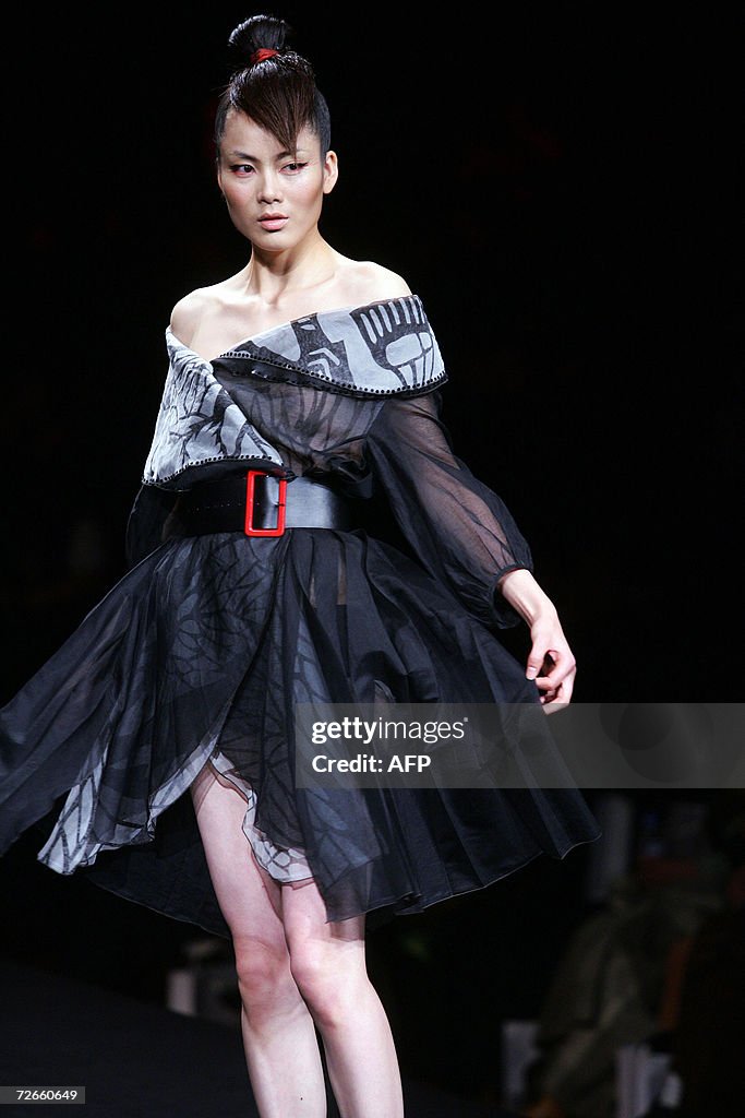 Liang Li Model A model parades the latest from the Liangzi Fashion collection during ...
