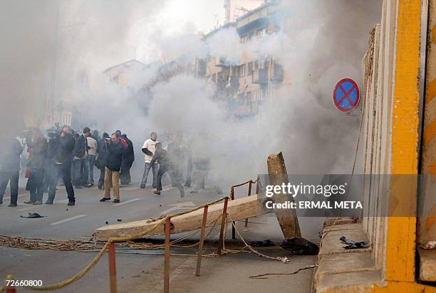Pristina, SERBIA AND MONTENEGRO: UN police intervene with tear gas after protesters overturn the wall around the UNMIK building, 28 November 2006....