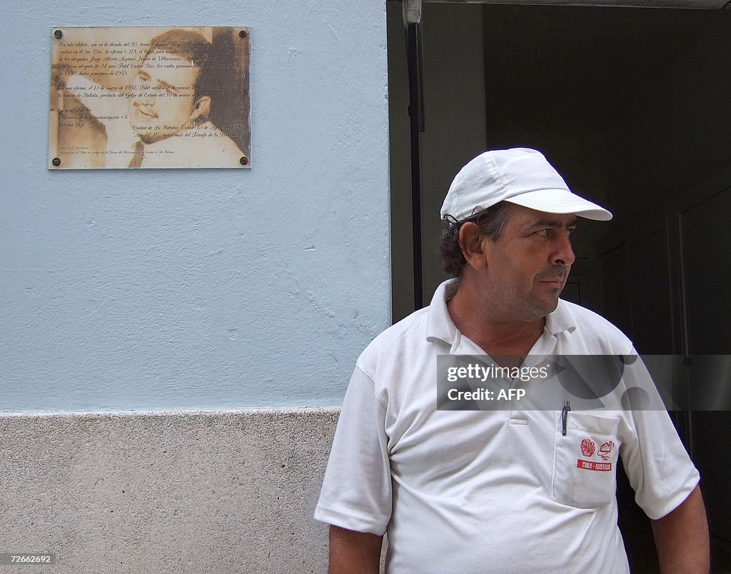 A Cuban stays near a plaque with an earl