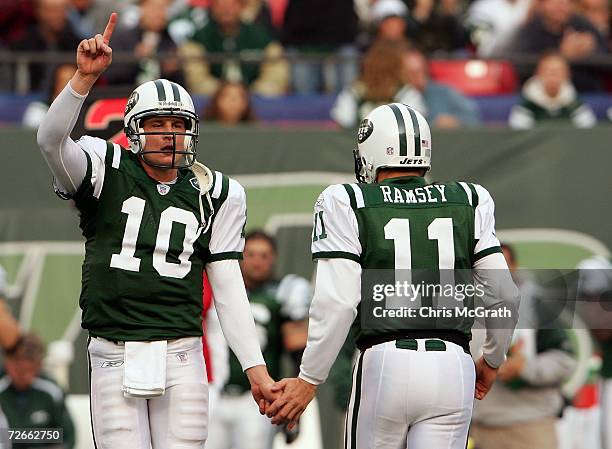 Quarterback Chad Pennington of the New York Jets high fives his backup Patrick Ramsey after coming back into the game against the Houston Texans at...