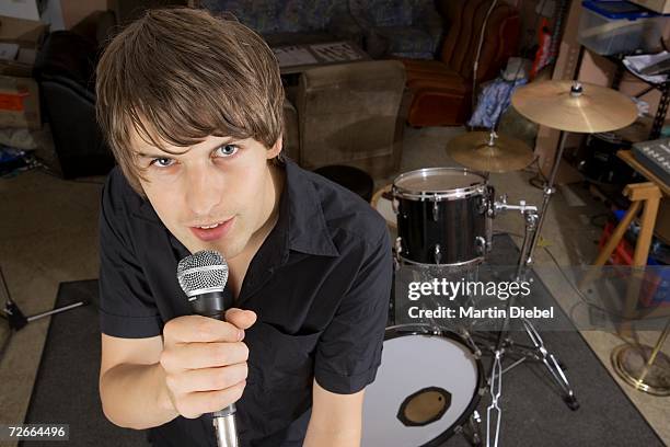 singer of band practicing in studio - rock band shirt stock pictures, royalty-free photos & images