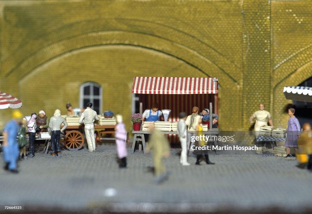 Model of people shopping at market stalls in town square