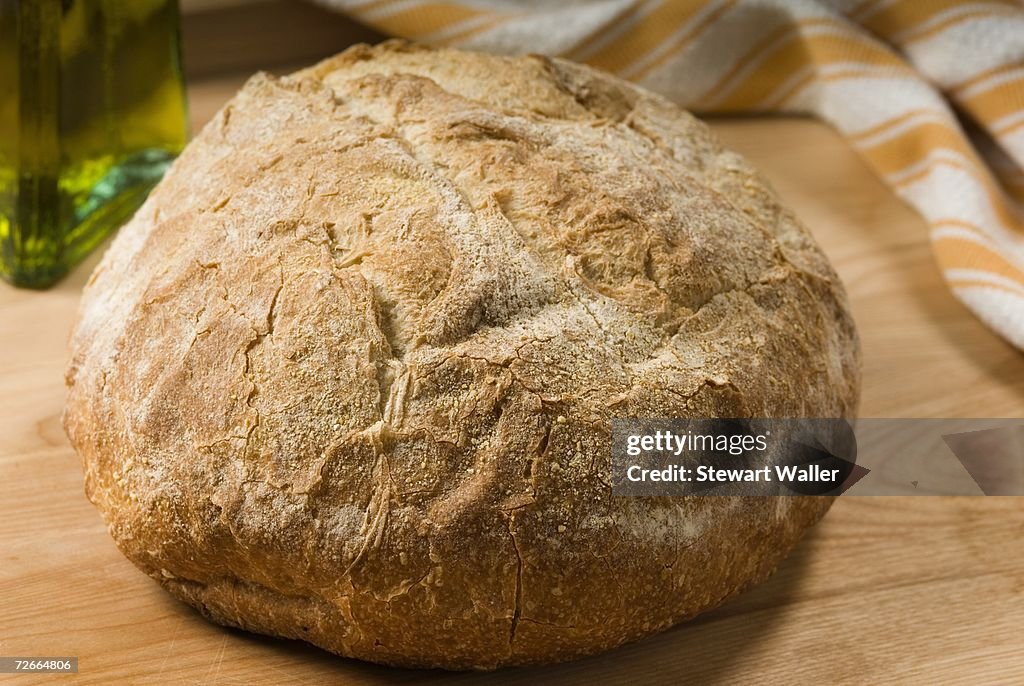 Loaf of bread on wooden bench