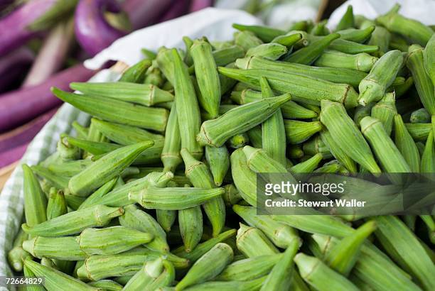 basket of okra at market stall - okra stock-fotos und bilder