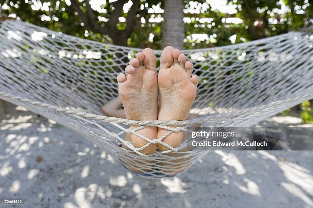 Close up of person?s feet lying in hammock
