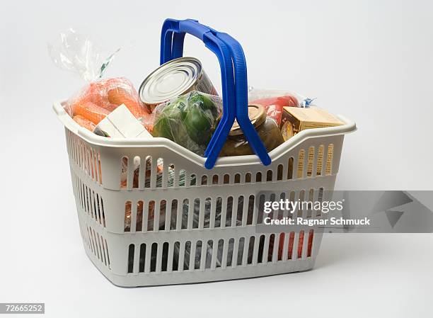 shopping basket full of groceries - stacked canned food stock pictures, royalty-free photos & images