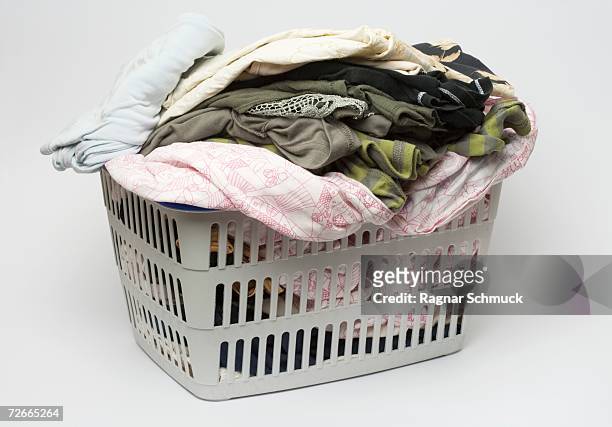 laundry basket full of clothes - washing basket stock pictures, royalty-free photos & images