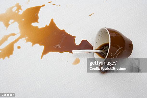 spilt cup of coffee - coffee spill on table stock pictures, royalty-free photos & images