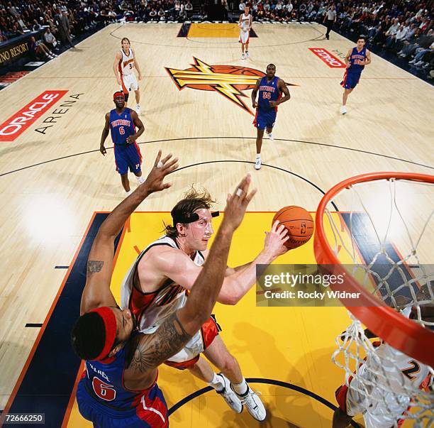 Troy Murphy of the Golden State Warriors takes the ball to the basket against Rasheed Wallace of the Detroit Pistons during a game at Oracle Arena on...