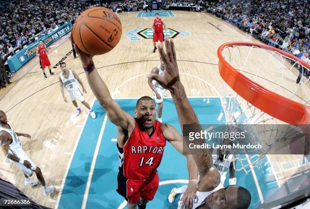 Joey Graham of the Toronto Raptors shoots the ball over Rasual Butler of the New Orleans/Oklahoma City Hornets on November 28, 2006 at the Ford...