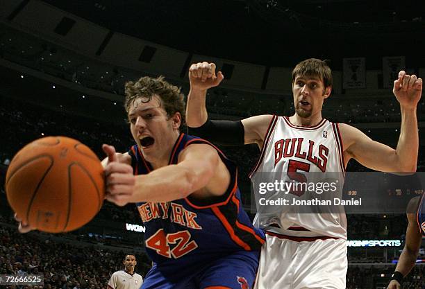 David Lee of the New York Knicks attempts to save the ball from going out of bounds against Andres Nocioni of the Chicago Bulls November 28, 2006 at...