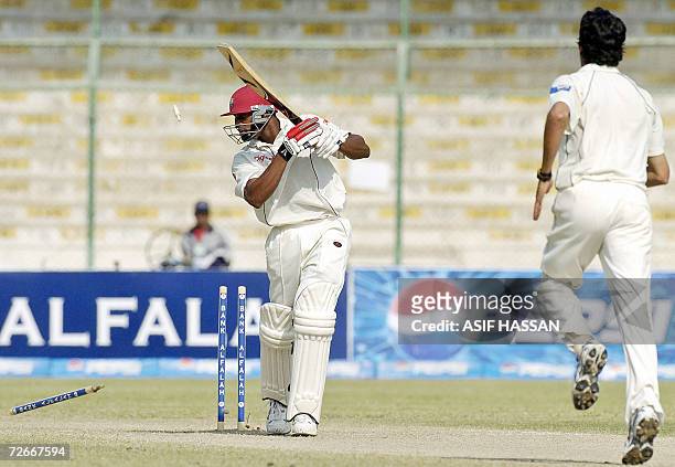 West Indies cricketer Daren Powell is clean bowled by Pakistan bowler Umar Gul during the third day of the third and final Test match between...