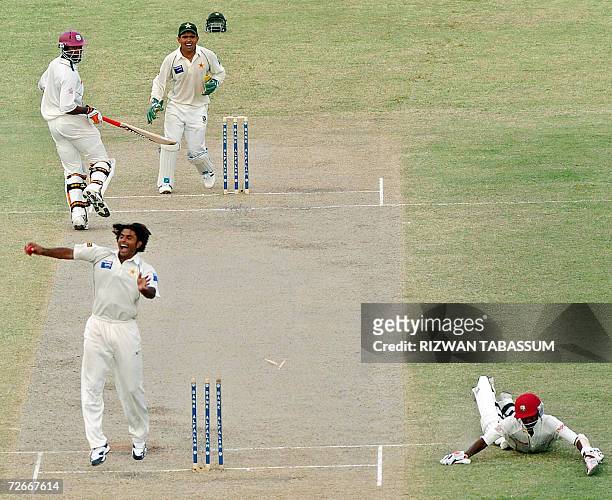 Pakistani cricketer Abdul Razzaq celebrates after dismissing West Indies cricketer Denesh Ramdin during the third day of the third and final Test...