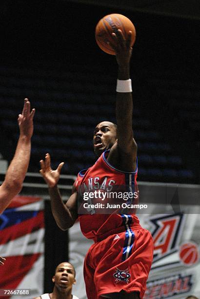 Jason Smith of the Arkansas RimRockers glides to the basket as Andre Owens of the Anaheim Arsenal looks on during their NBDL game on November 28,...