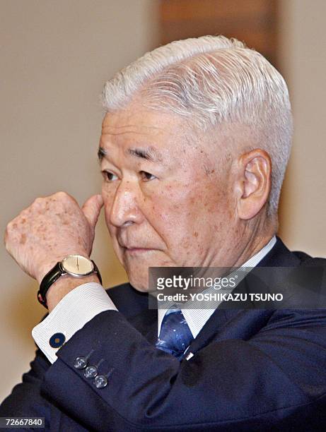 Bank of Japan Governor Toshihiko Fukui listens to the speech delivered by his French counterpart Christian Noyer at a business forum to encourage...