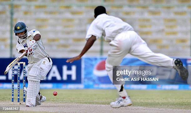 Pakistani cricketer Mohammad Hafeez plays a stroke off West Indies bowler Daren Powell during the third day of the third and final Test match between...