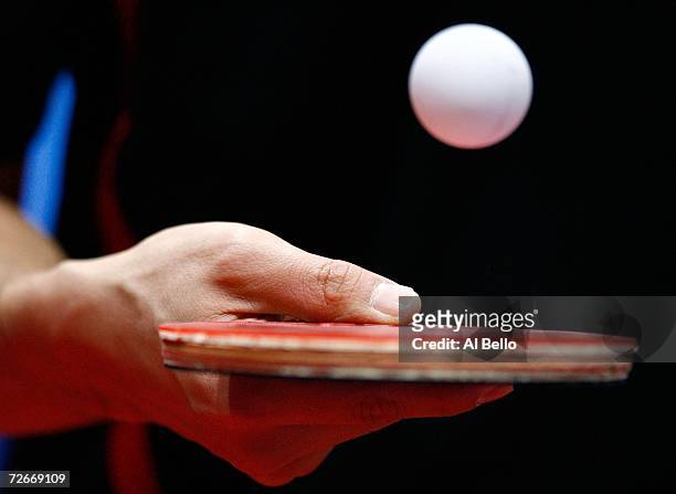 Player bounces a ball on his racquet before playing in the Men's Team Round One at the 15th Asian Games Doha 2006 at Al-Arabi Indoor Hall November...