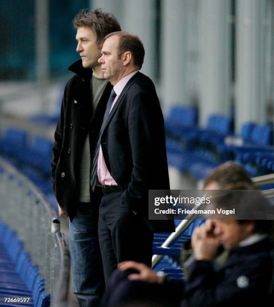 Manager Dietmar Beiersdorfer, President Bernd Hoffmann and Coach Thomas Doll watch the players during the training session of Hamburger SV on...