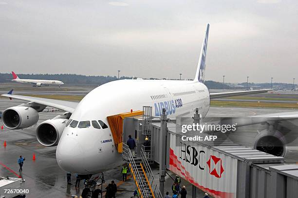 The double-decker superjumbo Airbus A380 jet parks at the gate upon its arrival at Narita Airport in Chiba prefecture, suburban Tokyo, 19 November...