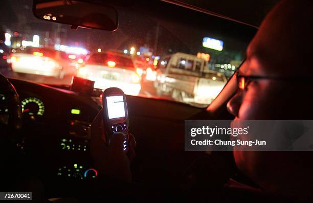 Ji Young-Hoon , controls an electronic appliance in his house using his mobile phone in a car on November 29, 2006 in Incheon, South Korea. The Home...