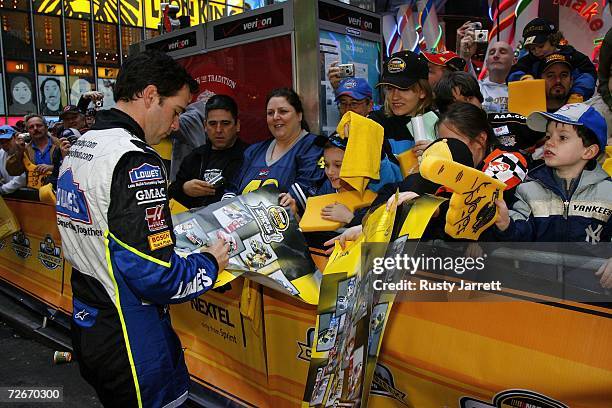 Jimmie Johnson, the 2006 NASCAR Nextel Cup Champion, signs autographs for fans, in Times Square on November 29, 2006 in New York City