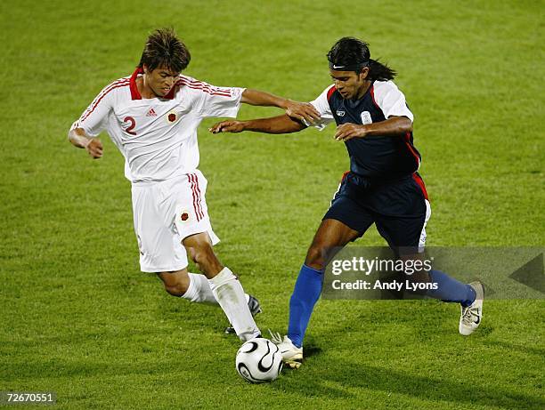 Manjit Singh of India holds off the challenge of Jun Sheng Lin of Hong Kong during the Men's Group D 2nd Round football match between India and Hong...