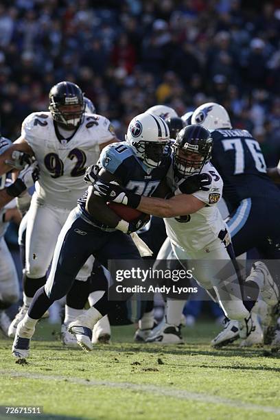 Travis Henry of the Tennessee Titans runs with the ball against Jarret Johnson of the Baltimore Ravens on November 12, 2006 at LP Field in Nashville,...