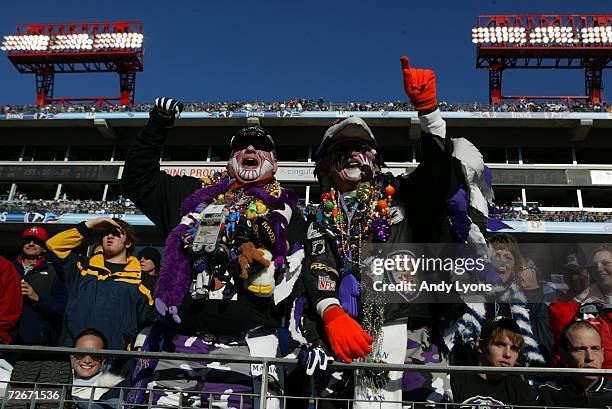 Fans of the Baltimore Ravens support their team dressed in team merchandise and with painted faces during the game against the Tennessee Titans on...