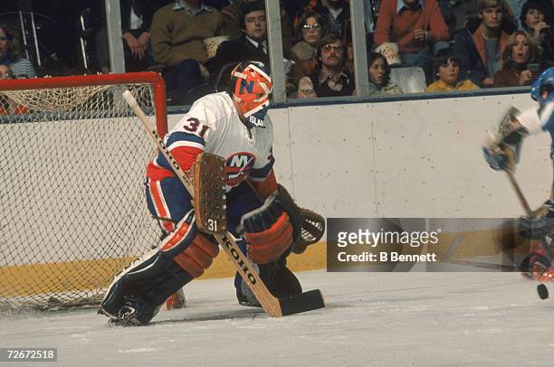 Canadian professional ice hockey player Billy Smith of the New York Islanders defends the goal during a home game, Nassau Coliseum, Uniondale, New...