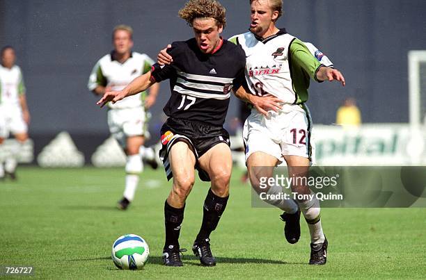 Chris Albright of the D.C. United moves with the ball while Brandon Pollard of the Dallas Burn guards him during the game at the RFK Stadium in...