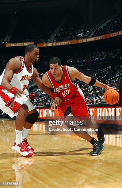 Sean May of the Charlotte Bobcats drives to the basket against Shelden Williams of the Atlanta Hawks at Philips Arena on November 29, 2006 in...