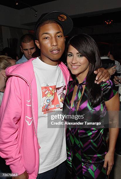 Music producer Pharrell Williams and Jackie Guerrido pose at the grand opening of Cielo Restaurant on November 29, 2006 in Coconut Grove, Florida.