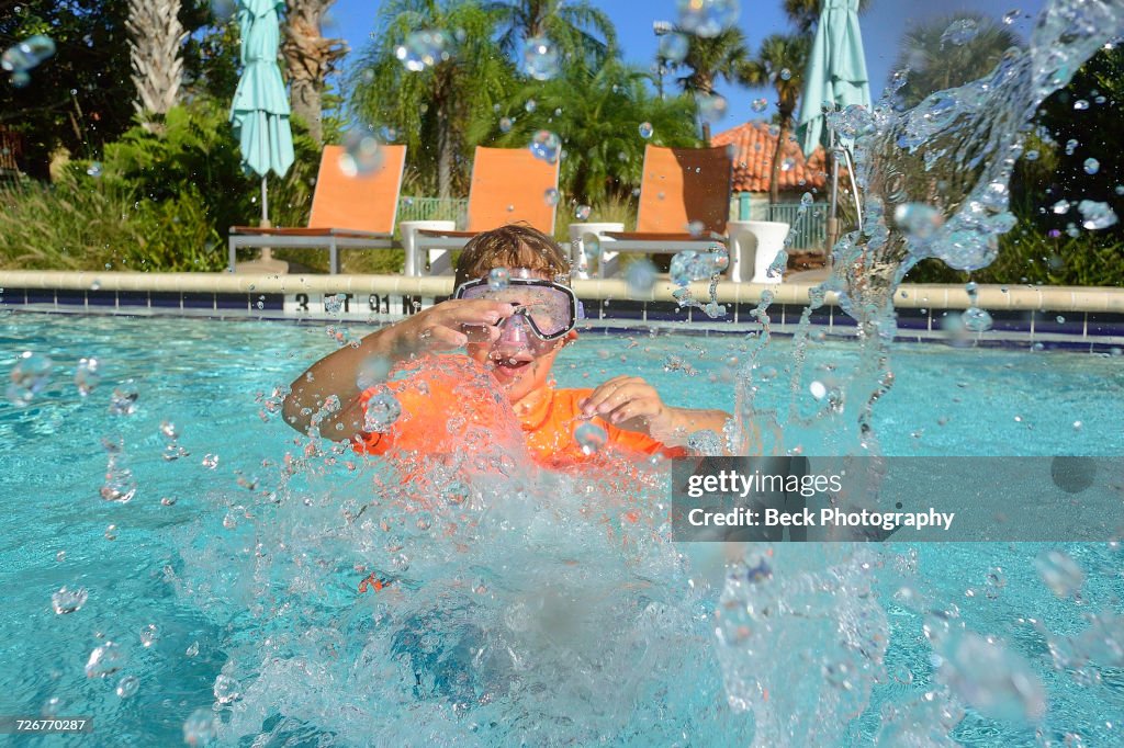 Boy swims in a pool