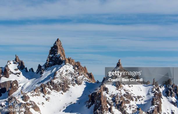 massive granite spires can be seen looking off the backside of the resort cerro catedral in argentina - nationaal park nahuel huapi stockfoto's en -beelden