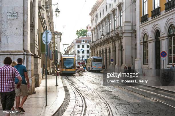 tramways in commerce square in lisbon - comercio stock-fotos und bilder