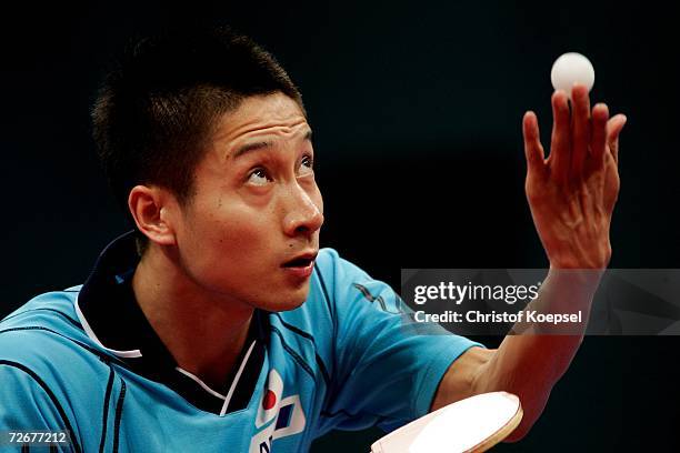 Kaii Yoshida of Japan serves to Ma Long of China during the Men's Table Tennis Team Stage One at the 15th Asian Games Doha 2006 at Al-Arabi Indoor...