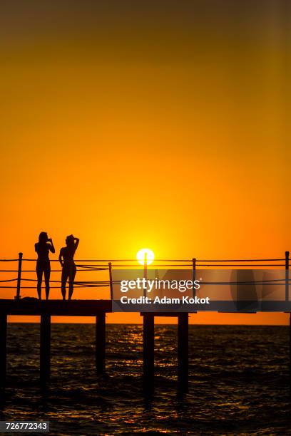 sexy girls on the pier during sunset in turkey - belek stock pictures, royalty-free photos & images