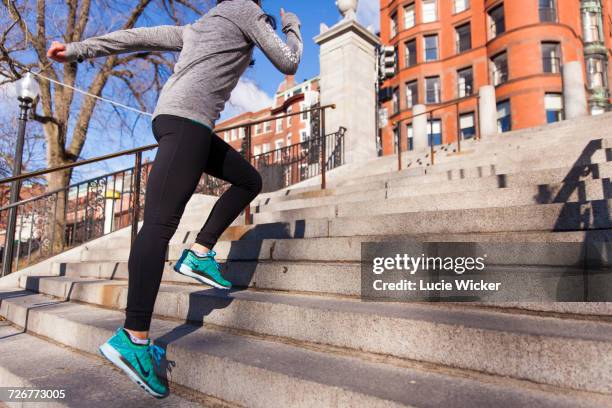 woman doing exercise on the staircase in the boston city - boston women ストックフォトと画像