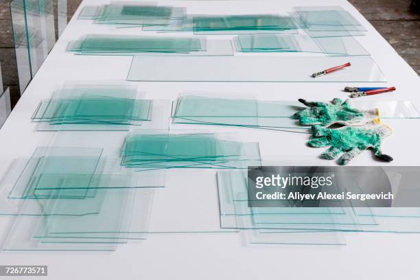 piles of glass and glass cutter on white table - glass cutter fotografías e imágenes de stock
