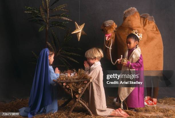 diverse children acting in nativity scene - natività foto e immagini stock
