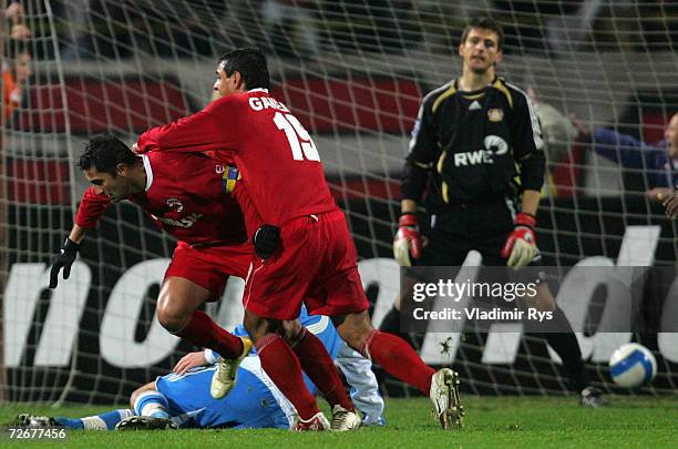 Claudiu Niculescu of Dinamo scores the third goal and is celebrated by his team mate Ionel Ganea as keeper Joerg Butt of Leverkusen looks dejected...