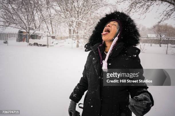 woman catching snow on tongue - catching snow stock pictures, royalty-free photos & images