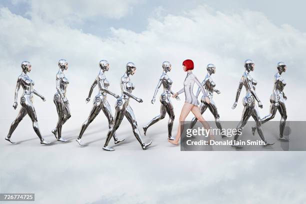 woman walking in opposite direction of robots - change attitude stock pictures, royalty-free photos & images