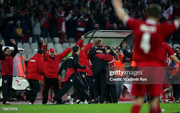 Coach Mircea Rednic of Dinamo is celebrated by the team after the final whistle of the UEFA Cup Group B match between Dinamo Bucharest and Bayer...