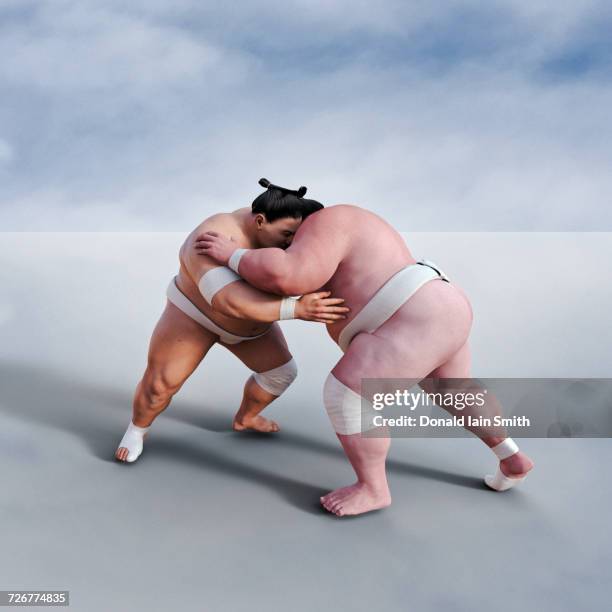 sumo wrestlers wresting - dueling stock pictures, royalty-free photos & images