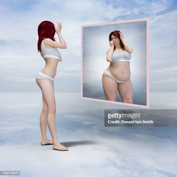 skinny woman viewing overweight reflection in floating mirror - anorexia nervosa stock pictures, royalty-free photos & images