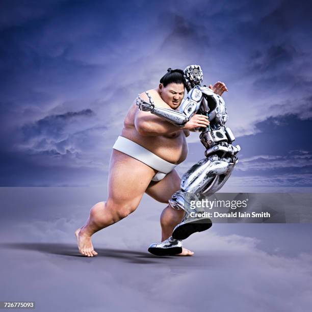sumo wrestler pushing robot - ringen stock-fotos und bilder