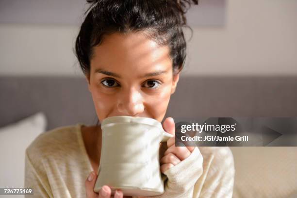 hispanic woman drinking coffee - this morning 2017 ストックフォトと画像