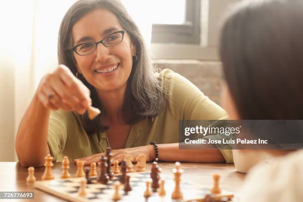 mother and daughter playing chess - asian games day 2 stock-fotos und bilder