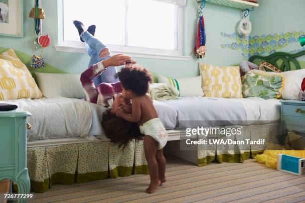 black baby boy kissing sister on forehead - chest kissing stockfoto's en -beelden
